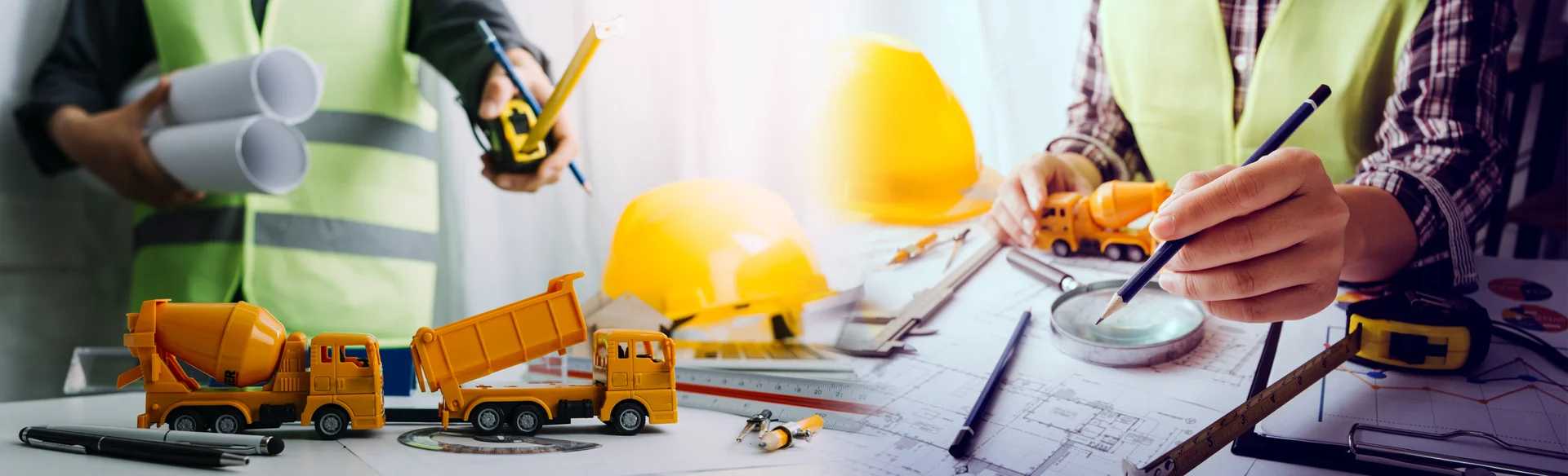 business hand working and laptop with on on architectural project at construction site at office desk in office